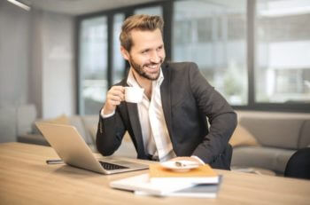 Man sitting at table with laptop